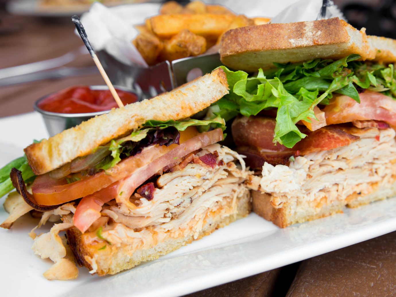 Delicious turkey club sandwich on toast with bacon, lettuce and tomato.