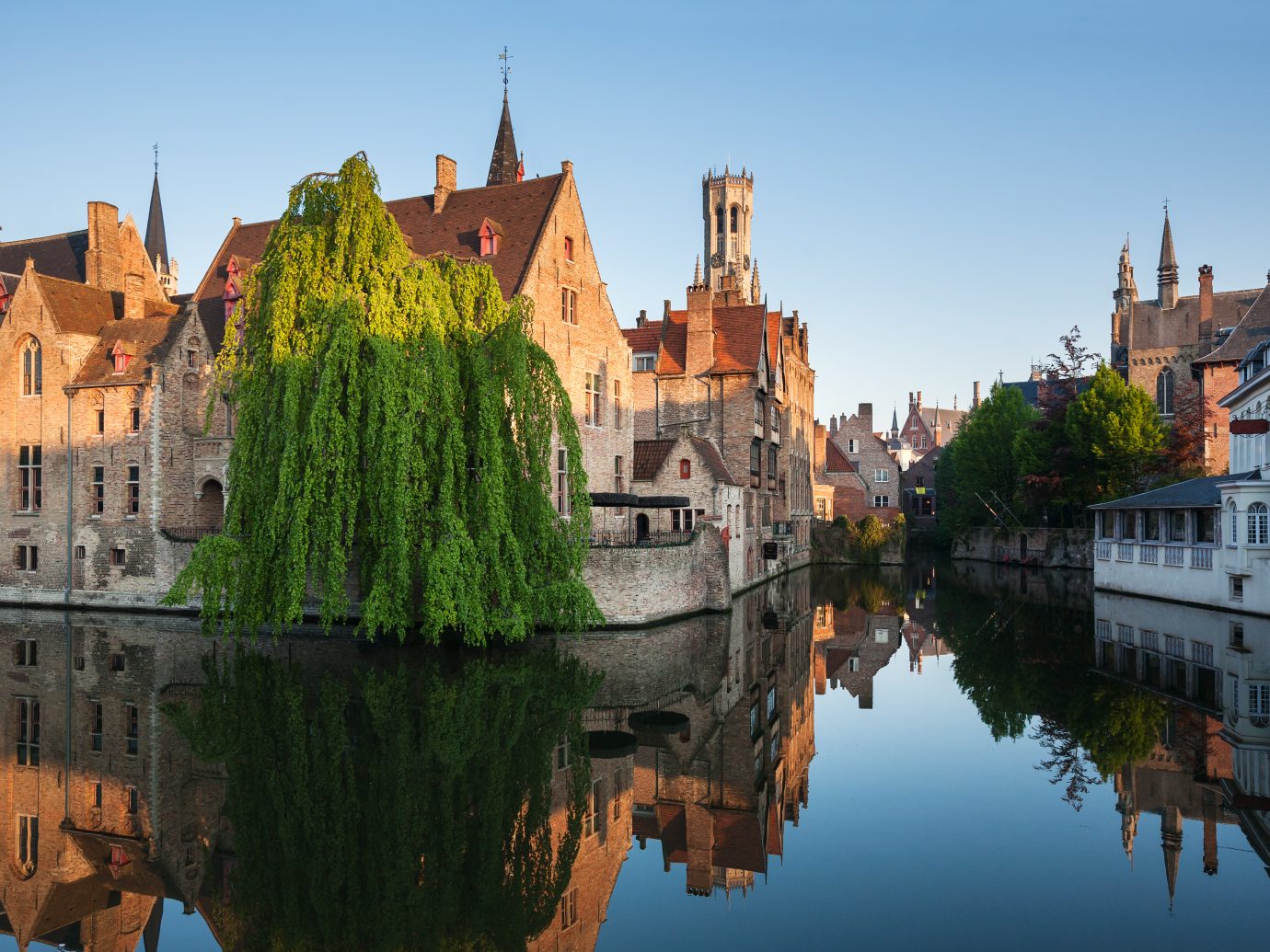 Rozenhoedkaai in Brugge, Dijver river canal twilight and Belfort tower.
