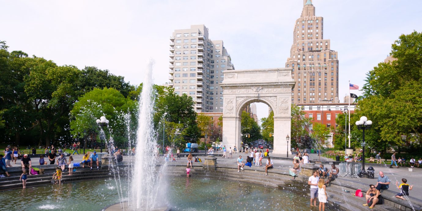 People meander about the fountain at Washington Square Park near the Washington Square Arch at Greenwich Village in the Manhattan borough of New York City.