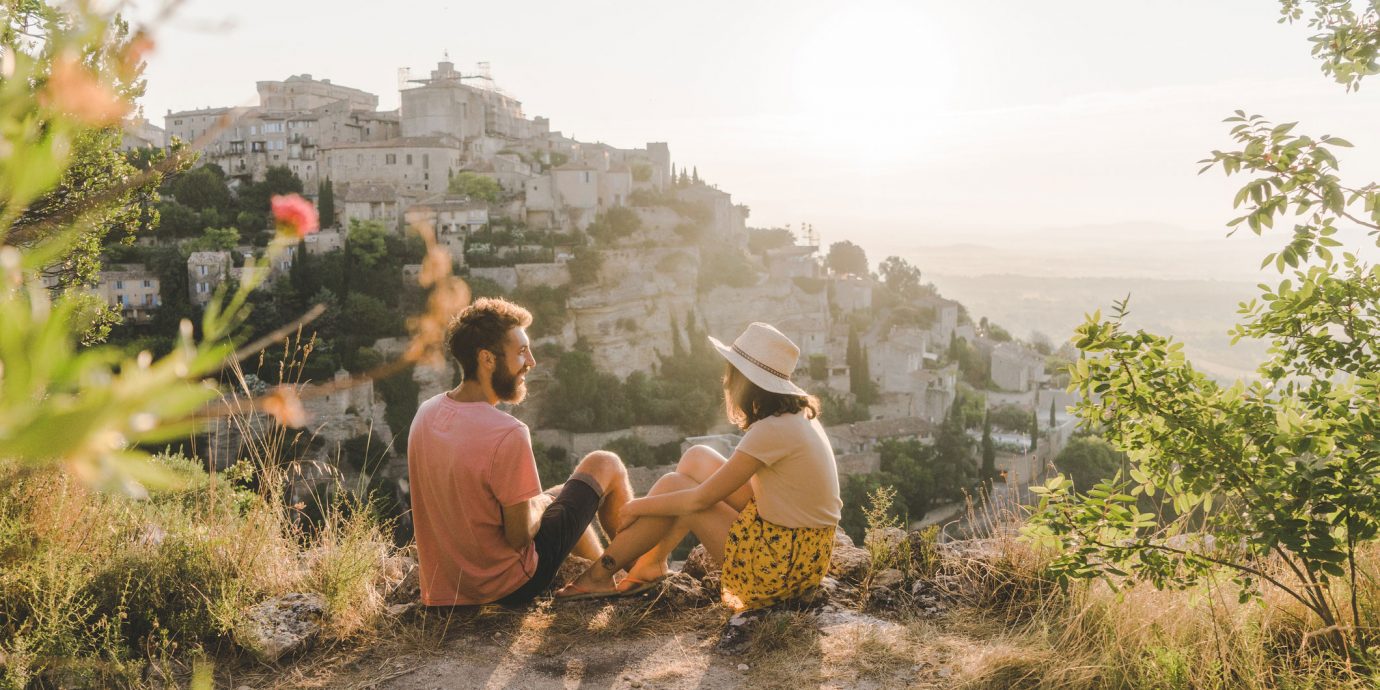 couple on a hilltop at sunset in europe