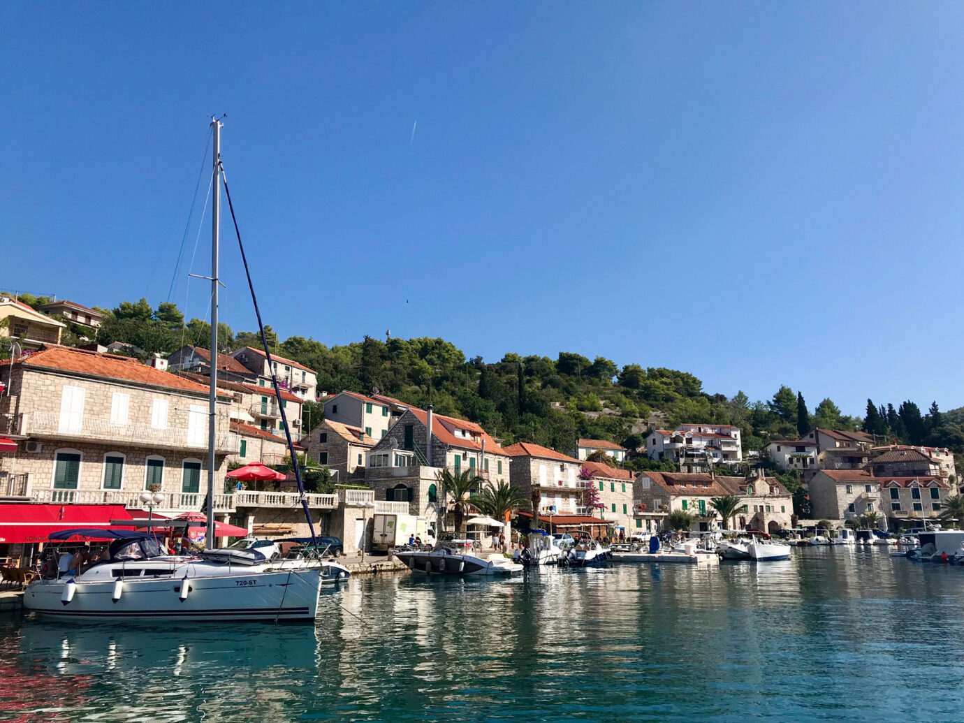 boats along the shore on the coast of Šolta, Croatia