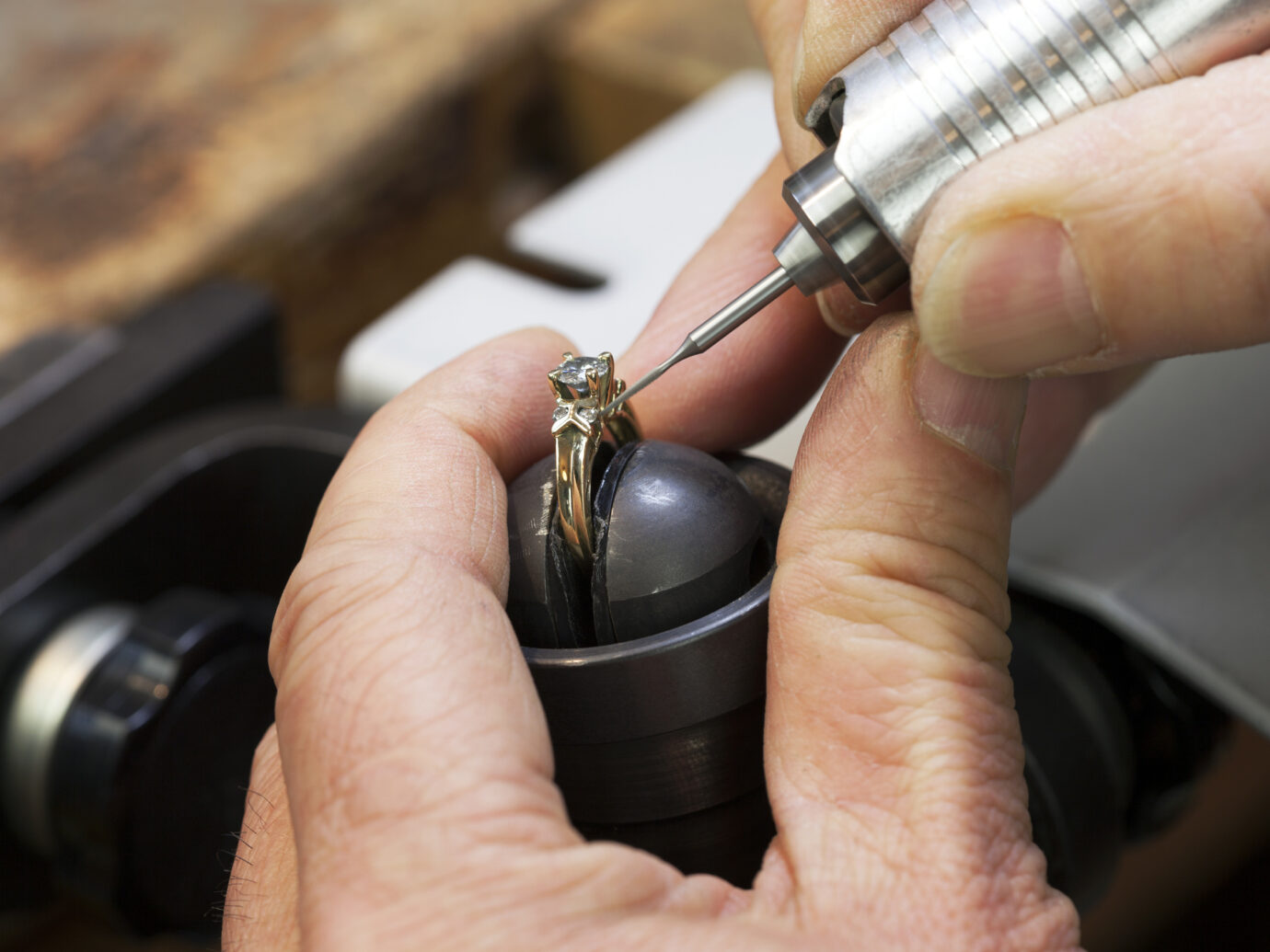 A Jeweller is Repairing a Diamond Ring.