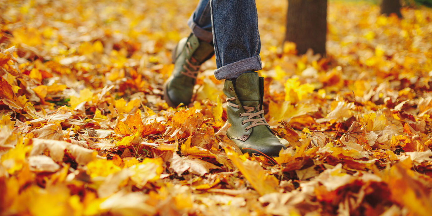 Leather shoes walking on fall leaves outside