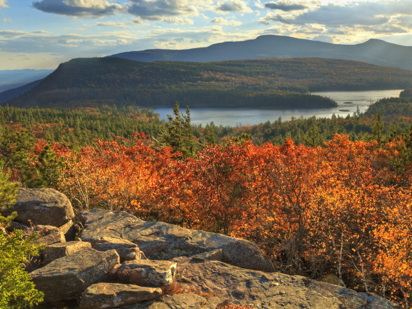 "Afternoon sun on sunset rock in the Autumn, overlooking North-South Lake in the Catskills Mountains of New York.