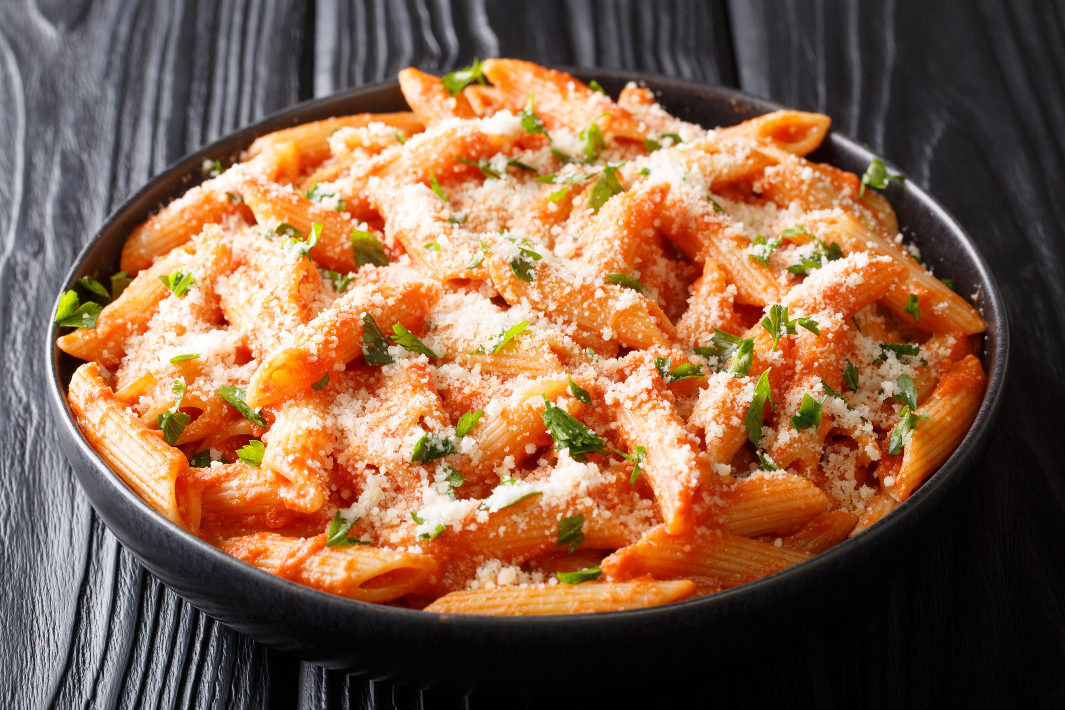 Penne alla Vodka is a classic Italian pasta dish made with penne in a creamy tomato and vodka sauce close-up in a plate